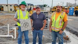 RBI employee William (Rick) Stuples holding his retirement plaque with his Superintendent Roy Ruddle and Manager Scott Andrews.