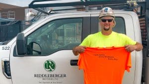 RBI employee Brian Beverage holding his Safety Champion shirt
