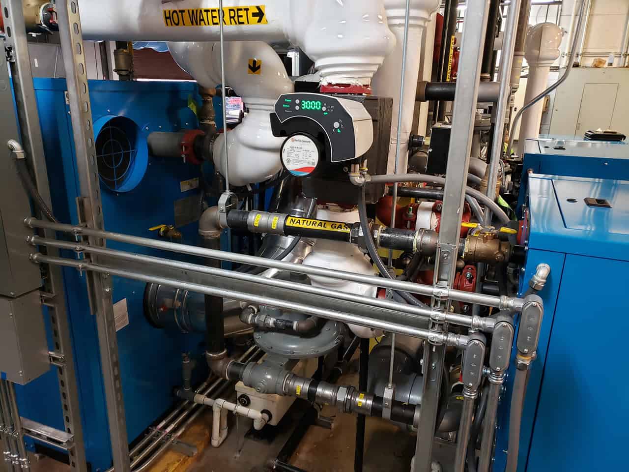 Pipes and controls on a commercial boiler system.