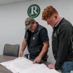 RBI refrigeration mechanic, Caleb Jerrels, looking over blueprints with a coworker