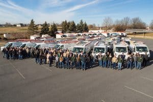 Group of RBI employees in front of RBI vehicles.