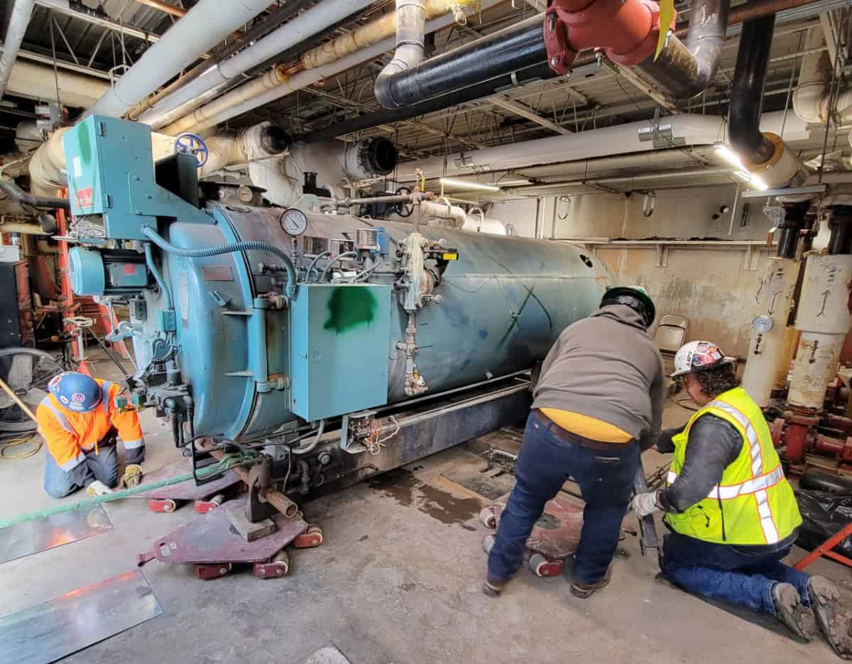 RBI employees removing a boiler from a commercial building.