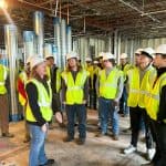 Students touring an in-progress facility