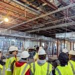 Students touring an in-progress facility