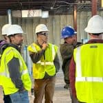 Students touring an in-progress facility