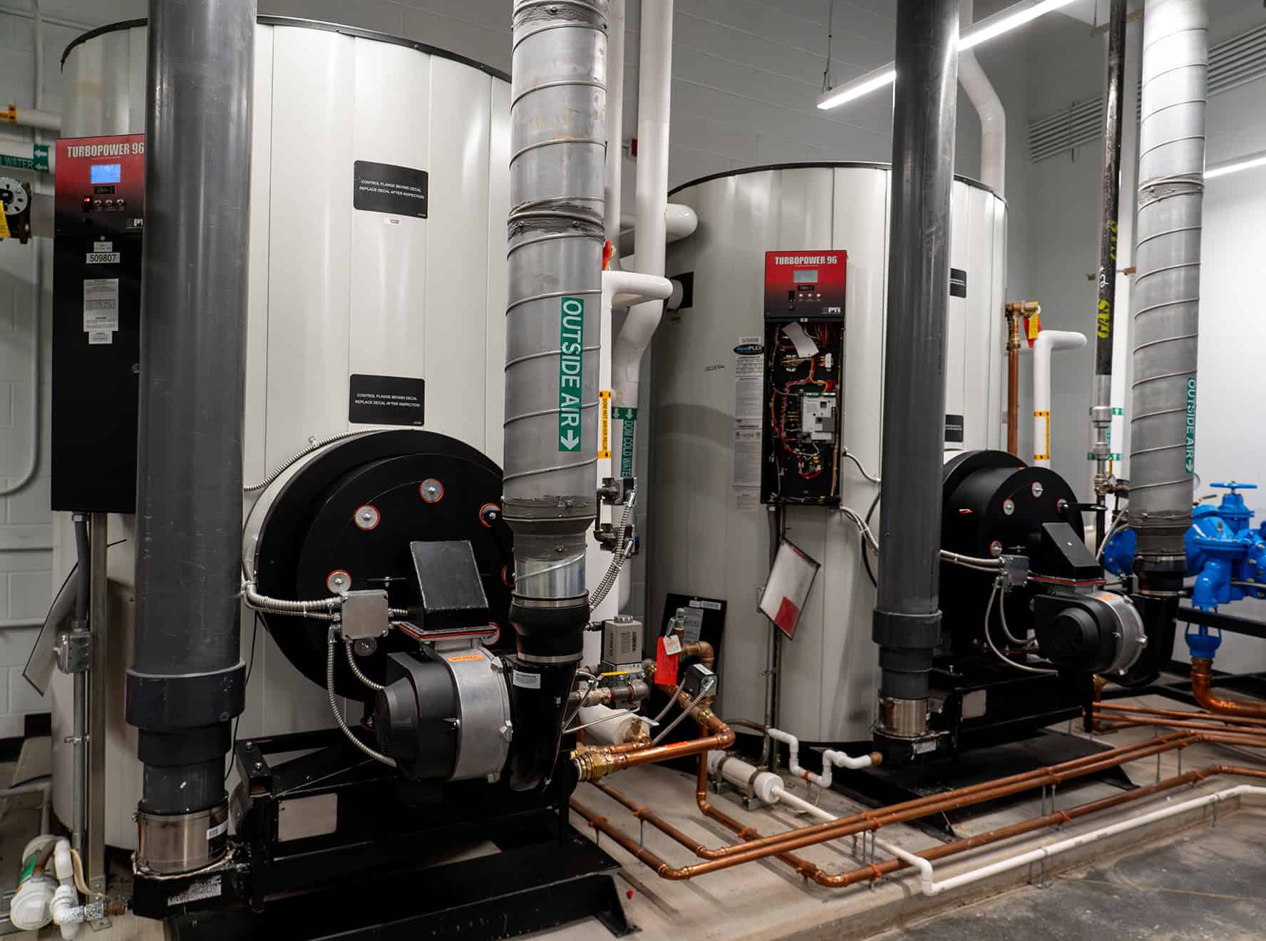 RBI-Summer-Building-Maintenance-Plumbing-Maintenance Commercial water heaters and plumbing lines installed in a facility.