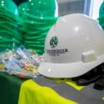 RBI hard hat, safety vest, ear plugs, and other PPE on a table