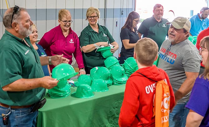 RBI 2025 Rockingham County Worlds of Work Students and RBI team members at a table with green hard hats