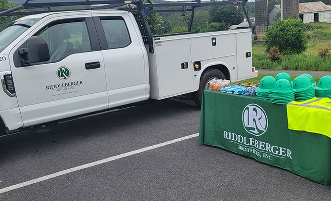 RBI 2025 Touch A Truck Event An RBI pickup truck next to a table of RBI merch