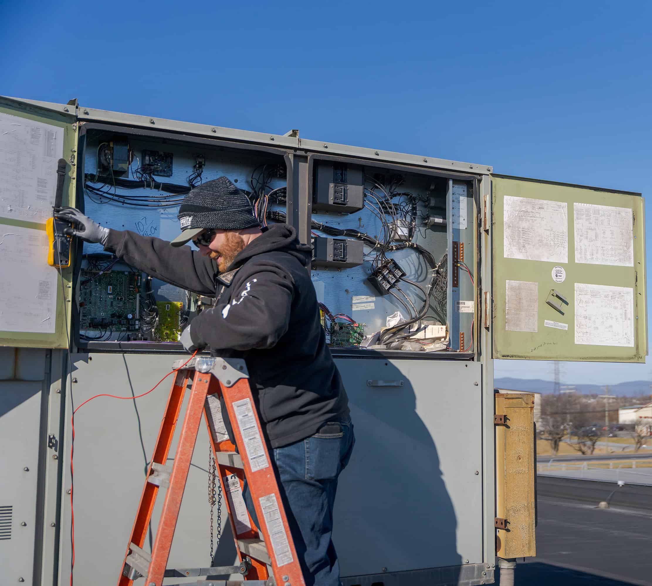 RBI technician inspecting a rooftop unit