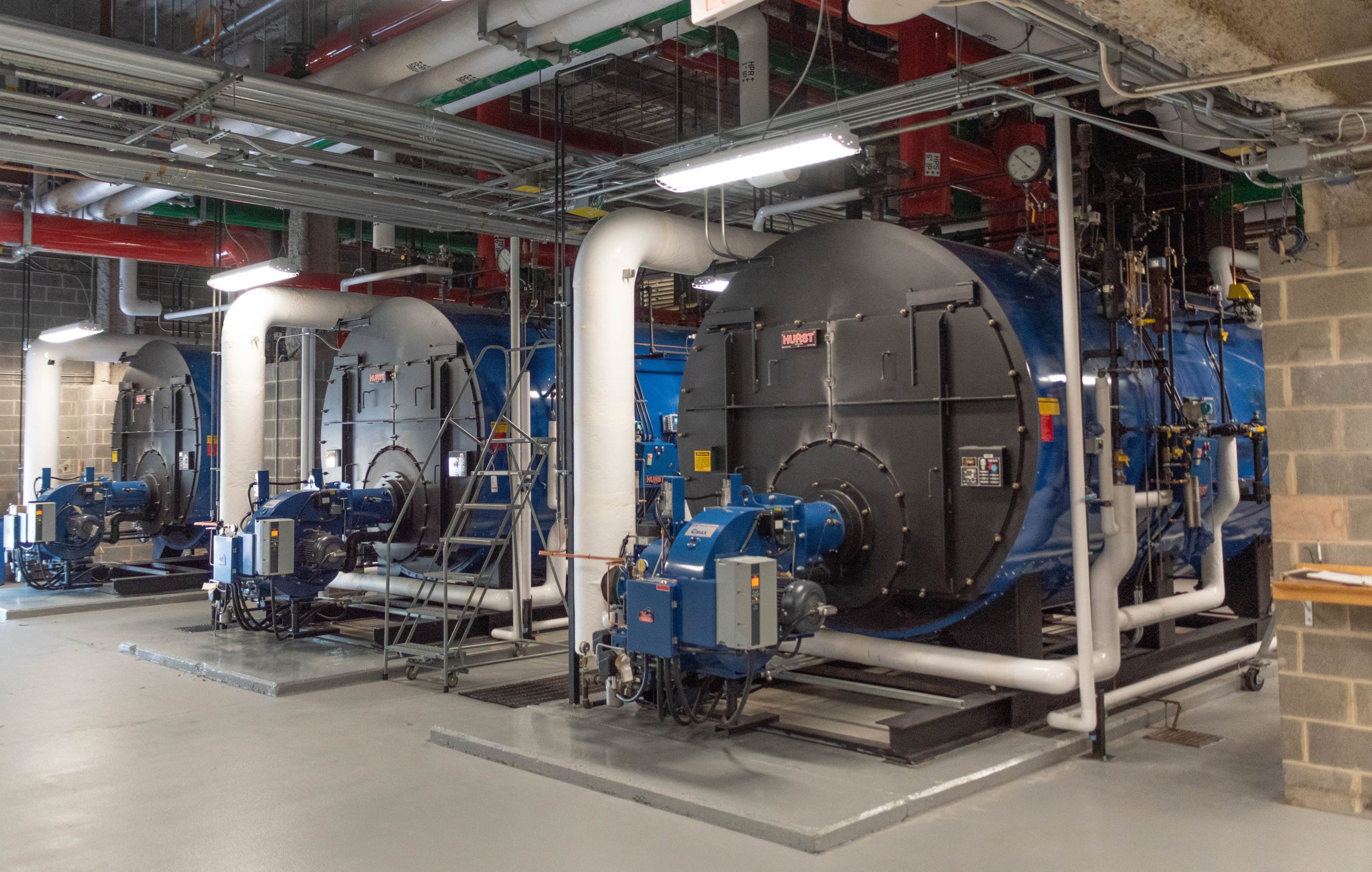 Three commercial boilers in a boiler room